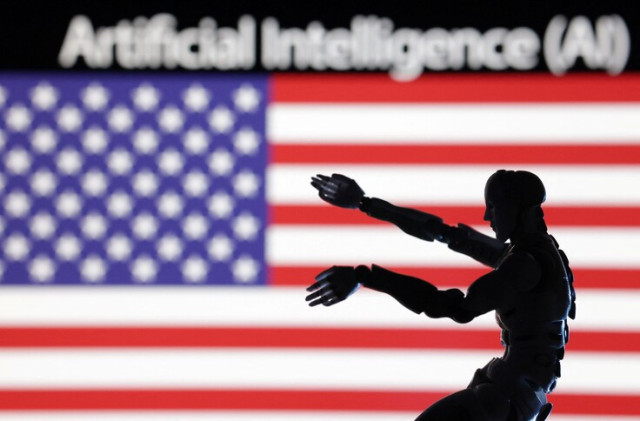 AI Artificial intelligence words, a robot miniature and a U.S. flag are seen in this illustration taken December 21, 2023